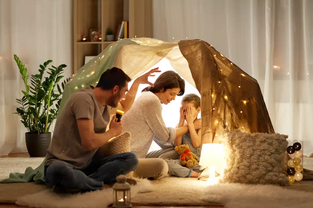 family telling stories under homeade tent; renovate or move